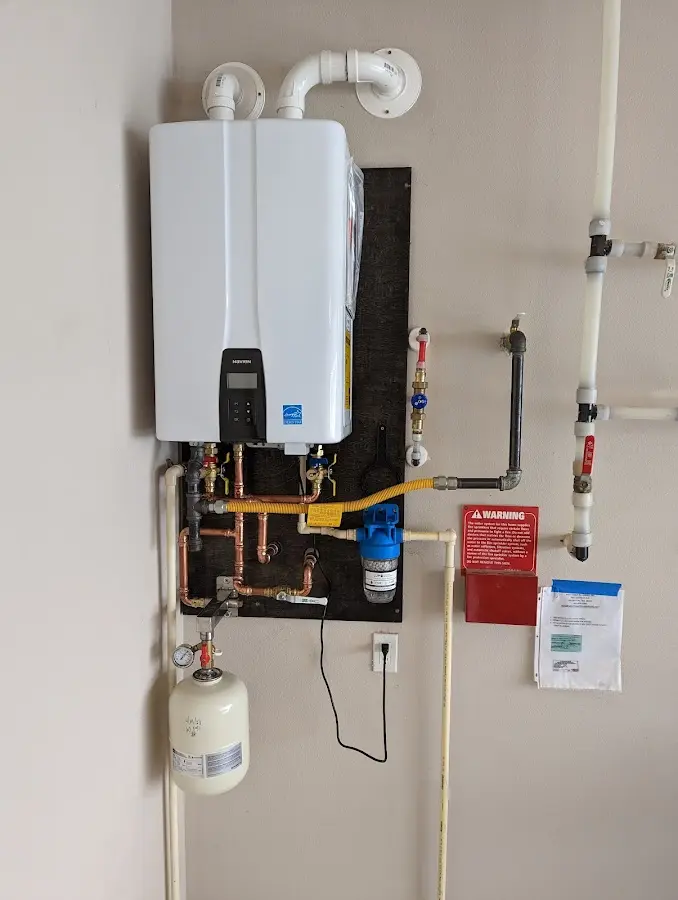 Professional plumber installing copper piping in a Withamsville home